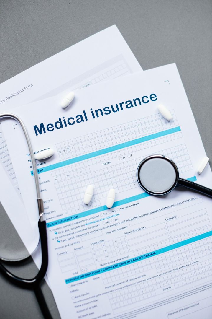 Medical insurance claim form with a stethoscope and pills