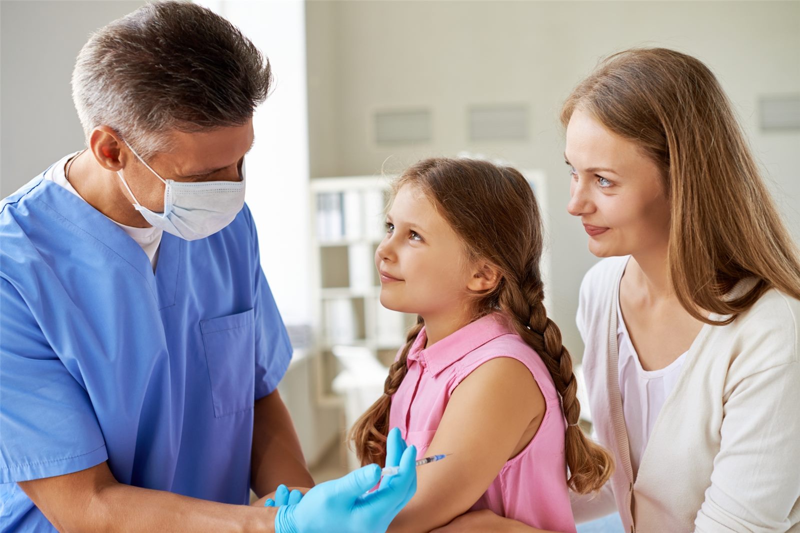 Clinician vaccinating a child during a community health drive